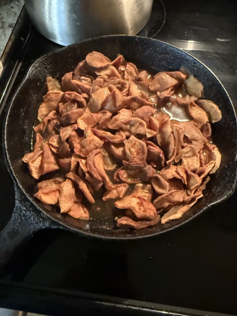 Dried apples for stack cake cooking in a cast iron skillet. 
